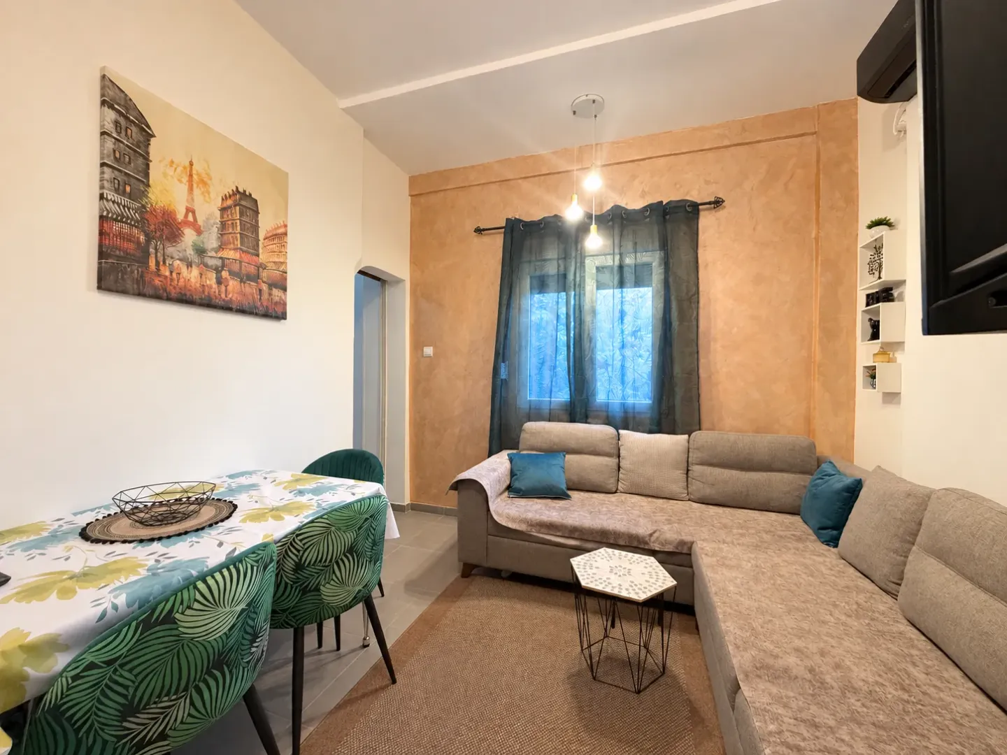 Comfortable living room with a corner sofa and a dining table.