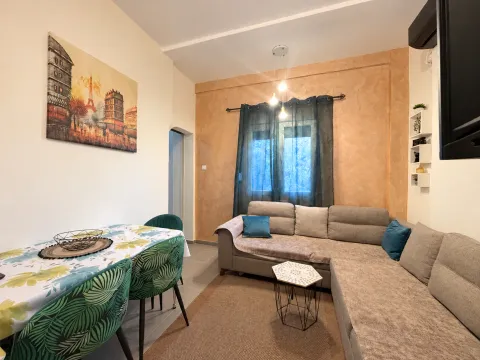 Comfortable living room with a corner sofa and a dining table. - image 2