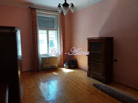 Empty room with wooden flooring, a window, and an old cabinet. - image 6