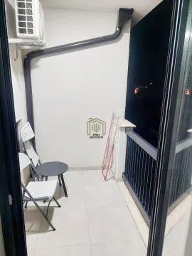 Smaller covered balcony with a table, chairs, and a clothes drying rack. - image 5