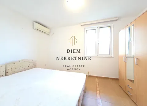 Furnished bedroom with a double bed, wardrobe, and air conditioning. - image 8
