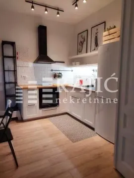Modern white kitchen with wooden countertops and built-in appliances. - image 13