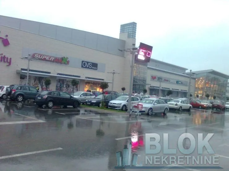 View of the exterior of the shopping center with a parking lot.