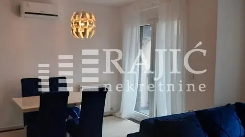 Living room with a dining table and sofa set.
