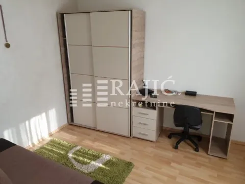 Furnished bedroom with a large wardrobe and a desk. - image 12