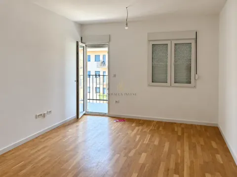 Empty room with hardwood flooring, a window, and a balcony door. - image 4