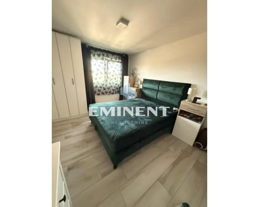 Furnished bedroom with a double bed and wardrobe.