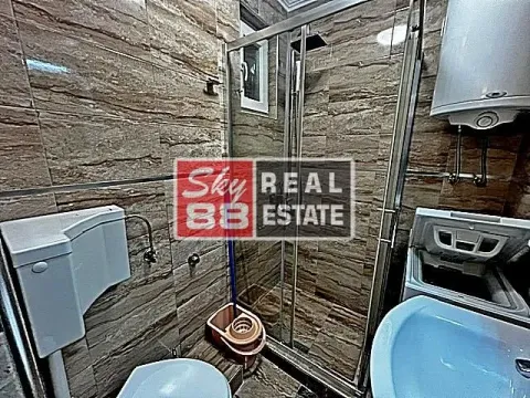 Bathroom with a shower cabin, washbasin, and toilet bowl tiled with marble pattern tiles. - image 17