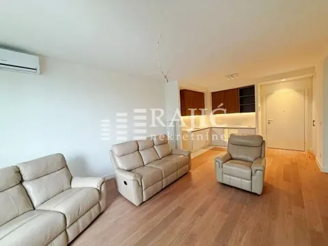 Spacious living room with seating area and view of the kitchen. - image 2