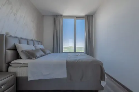 Modern bedroom with a double bed and a large window. - image 4