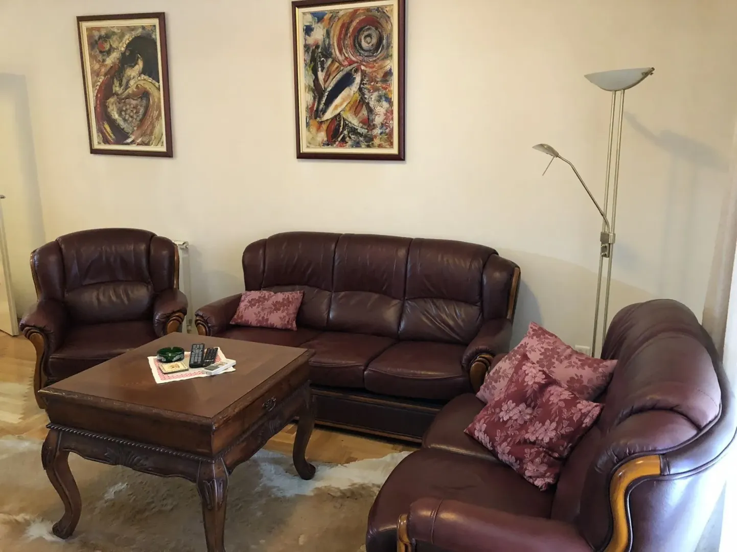 A living room with leather furniture and a wooden coffee table.