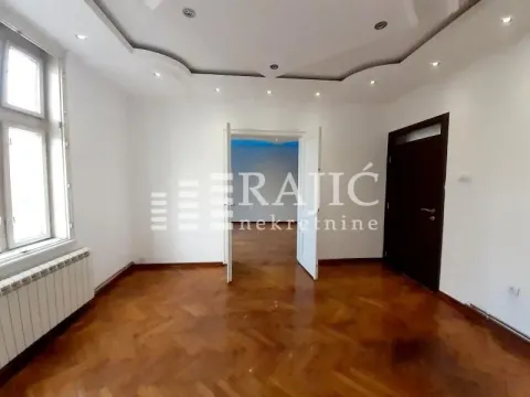 Empty room with parquet flooring and a dropped ceiling. - image 3