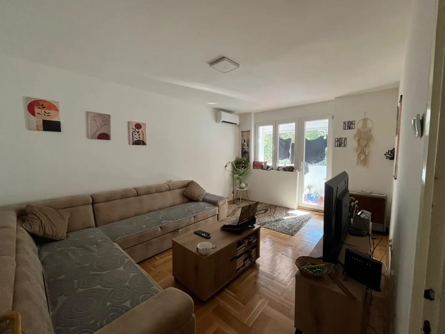 Living room with a sectional sofa, coffee table, and TV.