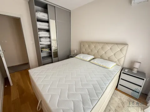 Furnished bedroom with a double bed, wardrobe, and nightstand. - image 9