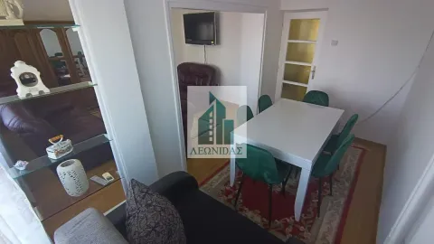 Living room with a dining table and chairs. - image 2
