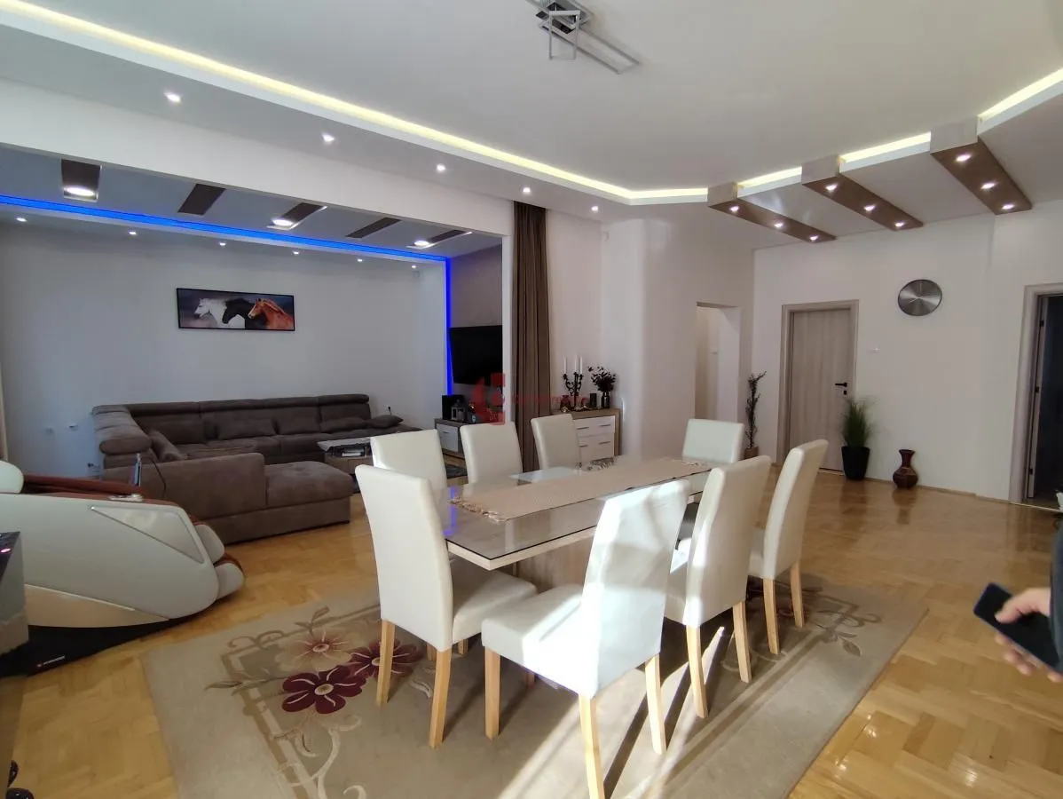 Living room with dining area and sofa seating.