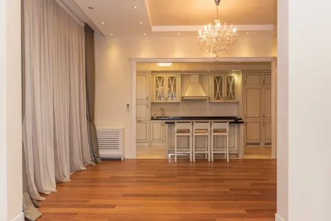 Spacious living room with wooden flooring and a view of the kitchen. - image 3