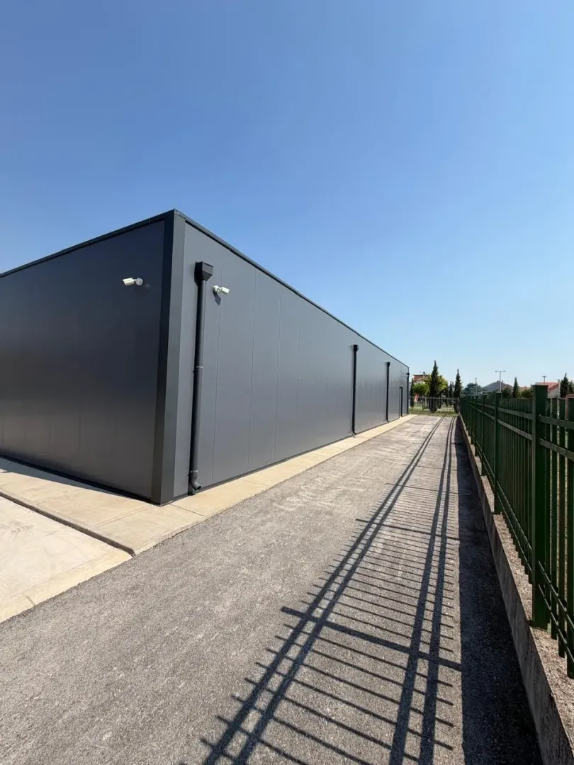 View of the exterior of a modern commercial building with a fence.