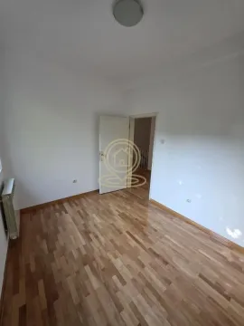 Empty room with wooden flooring and white walls. - image 7