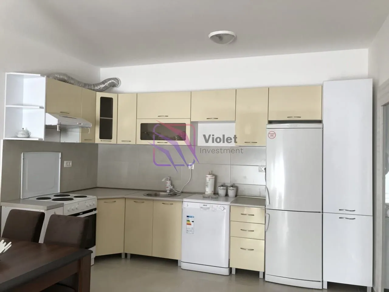 Kitchen equipped with cabinetry and household appliances.