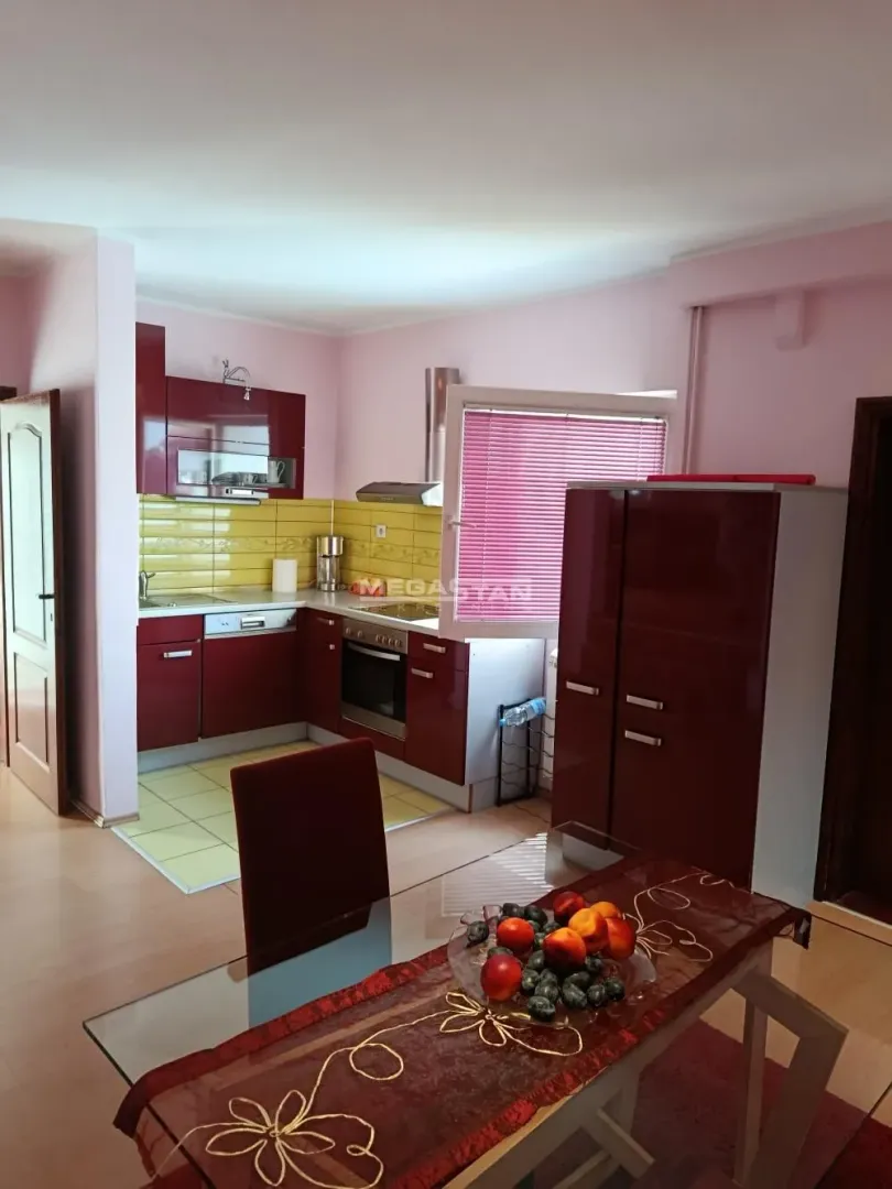 Kitchen with dining area and red cabinetry.