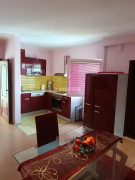 Kitchen with dining area and red cabinetry. - image 13