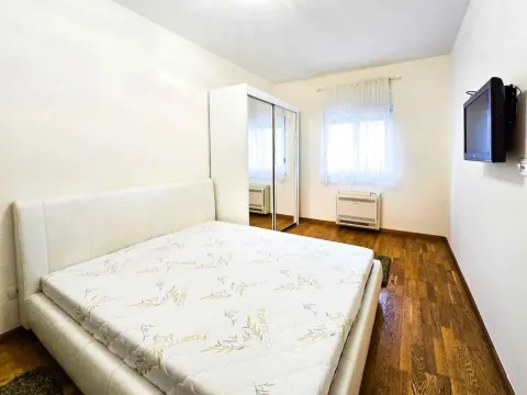 Bright bedroom with a double bed, wardrobe, and TV. - image 7
