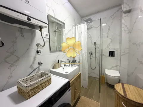 Modernly decorated bathroom with a shower cabin, washbasin, and toilet. - image 12