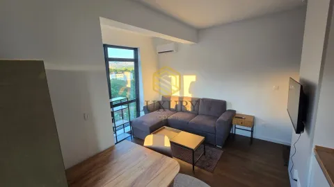 Living room with a sofa and dining table. - image 5