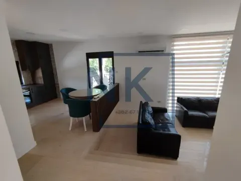 Living room with a sofa set, dining area, and kitchen in the background. - image 15