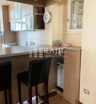 View of a modern equipped kitchen with a breakfast bar and bar stools. - image 4