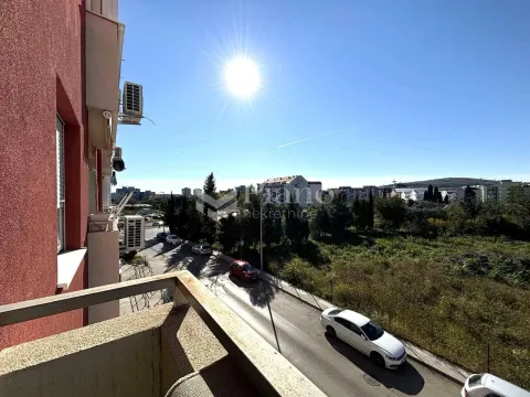 View from the balcony overlooking the street and surrounding buildings. - image 8
