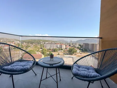 Furnished balcony with seating set and an open view of the city. - image 9