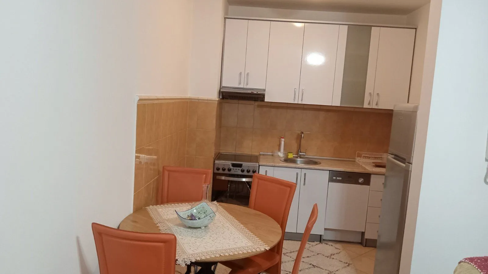 Kitchen with a dining table and white cabinets.