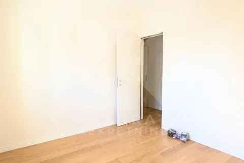 Empty bright room with wooden flooring and an open door. - image 10