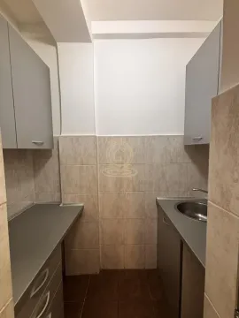 Small kitchen with a sink, countertops, and wall cabinets. - image 8