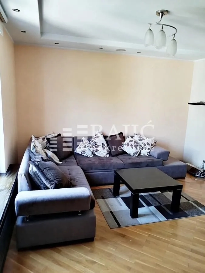 Living room with a large sectional sofa and coffee table.