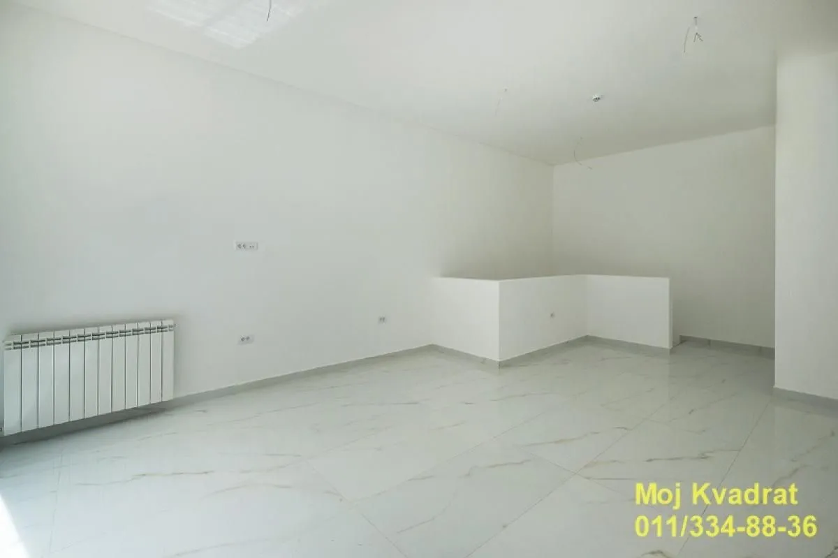 Empty bright room with white walls and ceramic floor tiles.