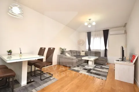 Living room with a sofa set, dining table and TV unit. - image 2