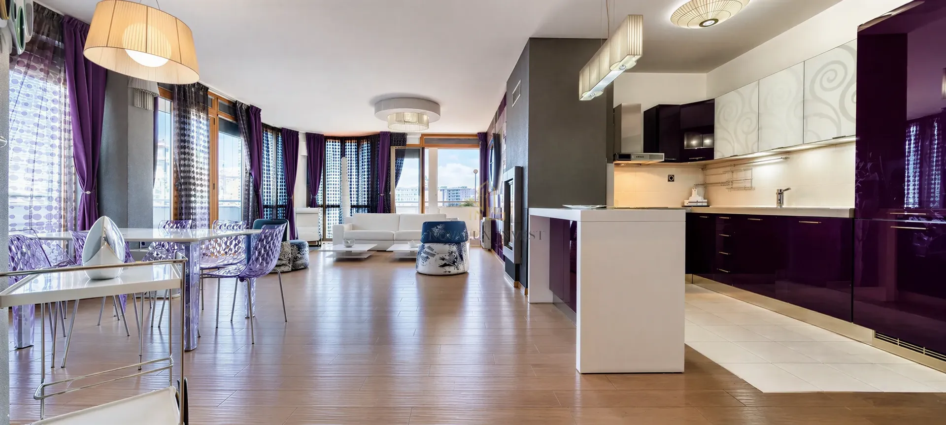 Spacious open-plan area combining the living room, dining area, and modern kitchen.