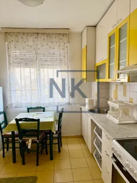 Kitchen with a dining area and a window facing outside. - image 3