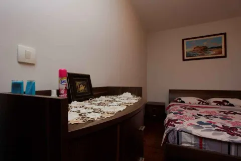 Simply furnished bedroom with a double bed and a chest of drawers. - image 12