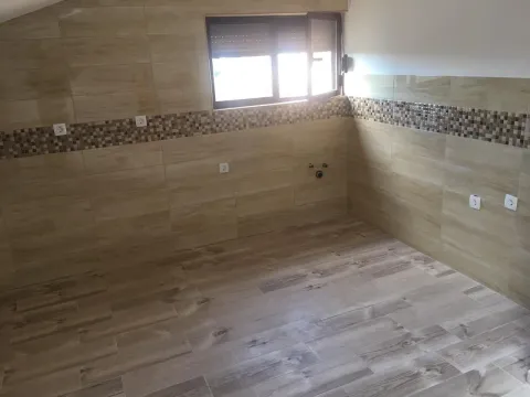 An empty room finished with ceramic tiles and a window. - image 5