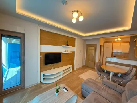 Living room with dining area and kitchen in the background. - image 3
