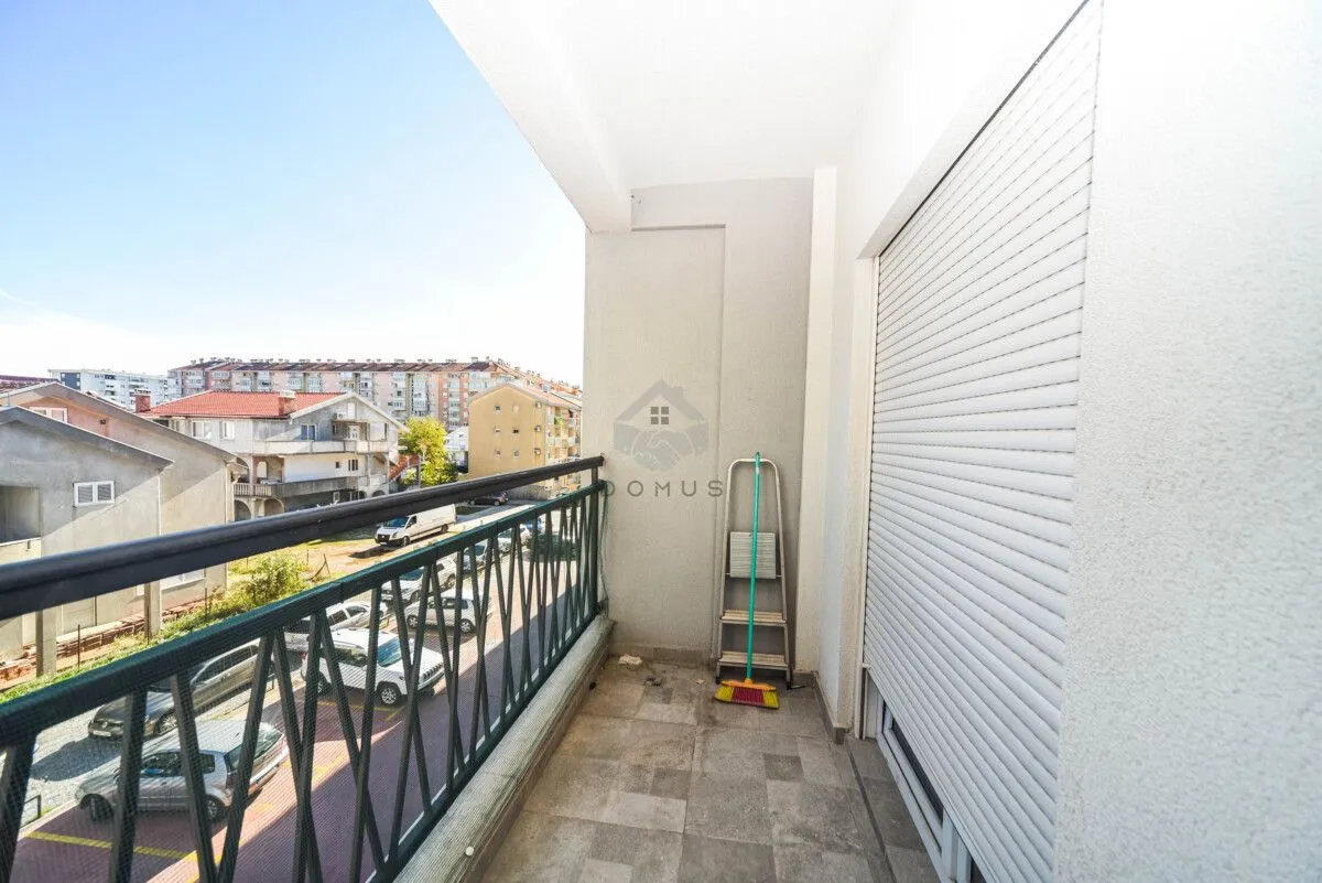 Unfurnished balcony with a metal railing and a view of the neighborhood.