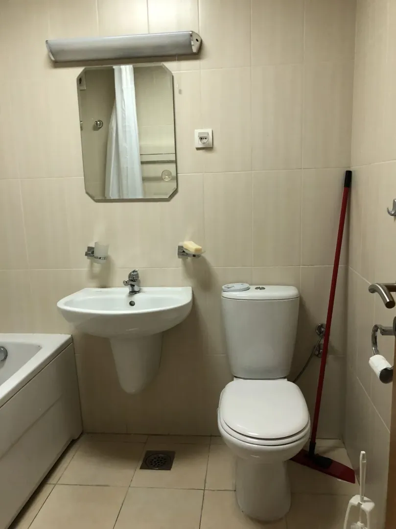 A simple bathroom with a sink and a mirror.