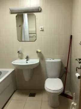 A simple bathroom with a sink and a mirror. - image 13