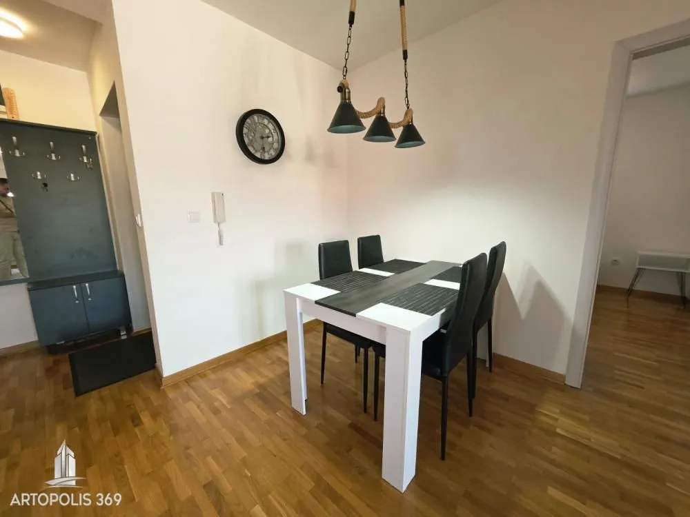 Dining area with a dining table and chairs, and a shoe cabinet in the hallway.