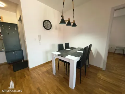 Dining area with a dining table and chairs, and a shoe cabinet in the hallway. - image 9