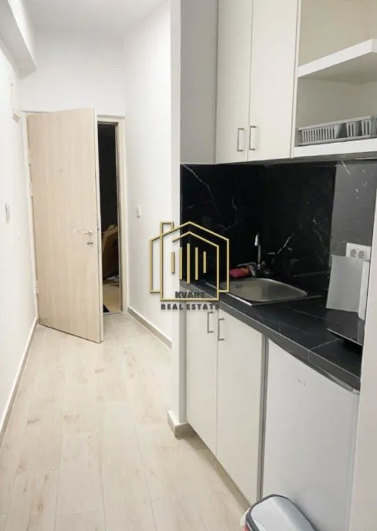 Small kitchen with a sink and built-in units in the hallway